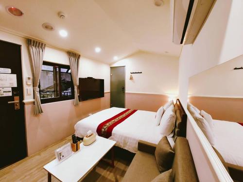 Cama o camas de una habitación en 櫻花樹夏民宿