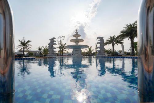 ein großer Pool mit einem Brunnen im Hintergrund in der Unterkunft Charmhill Hotel - Tuần Châu in Hạ Long