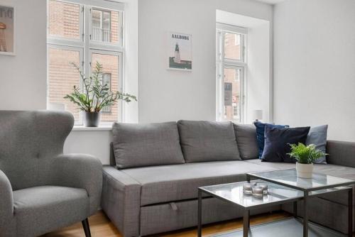 a living room with a couch and a chair at Apartment Near Pedestrian Street In Aalborg in Aalborg