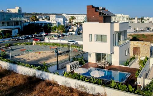 a house with a swimming pool and a parking lot at City Napa Seaview Villas - Villa 4 in Ayia Napa