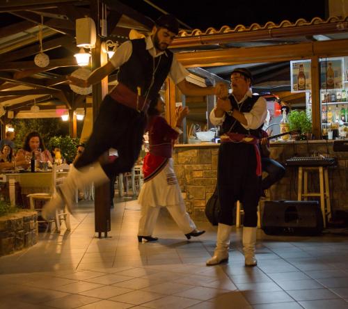 a group of men dancing on a dance floor at Aggello Boutique Hotel in Stalida