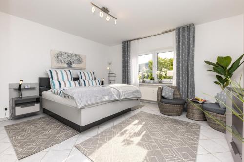 a bedroom with a bed and a window at Ferienwohnung Hoffmann in Netphen