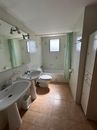 a bathroom with two sinks and a toilet at Apartamento duplex LOS IRIS solo familias in Playa de Gandia