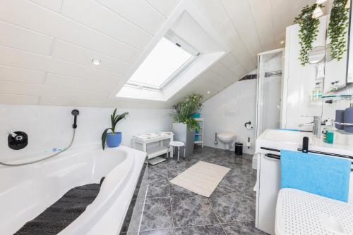 a bathroom with a tub and a sink and a shower at Ferienwohnung Hoffmann in Netphen