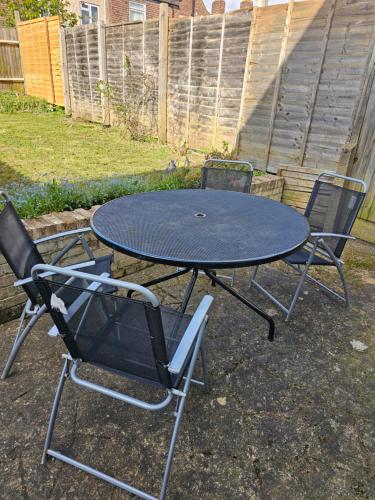 two chairs and a table in a yard at Luxury Home in Lewisham in Bromley