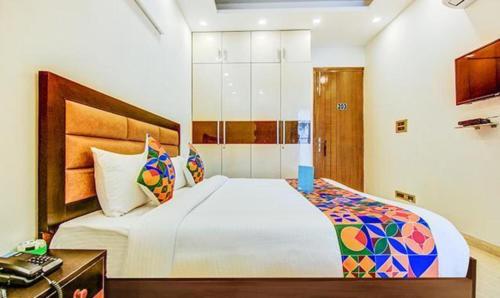 a bedroom with a large bed in a room at FabHotel F-Aloyd Lajpat Nagar in New Delhi