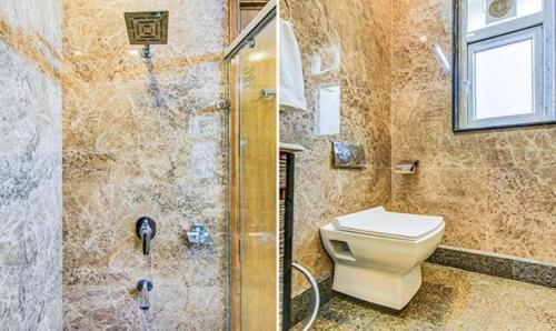 a bathroom with a toilet and a shower at FabHotel F-Aloyd Lajpat Nagar in New Delhi