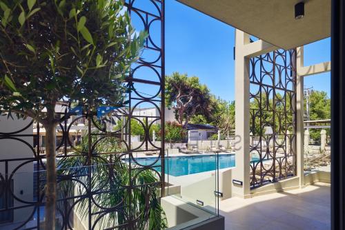 a view of a swimming pool from a house at Inea Sole Boutique Hotel in Kato Daratso