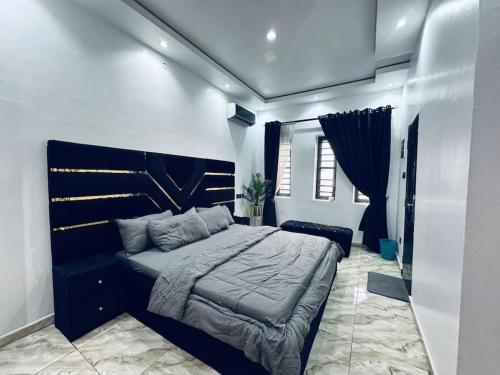 a bedroom with a large bed and a couch at Sweet Serenity with Lagos View in Lagos