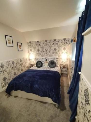 a bedroom with a bed with two pillows on it at La Croix Douillet in Gavray