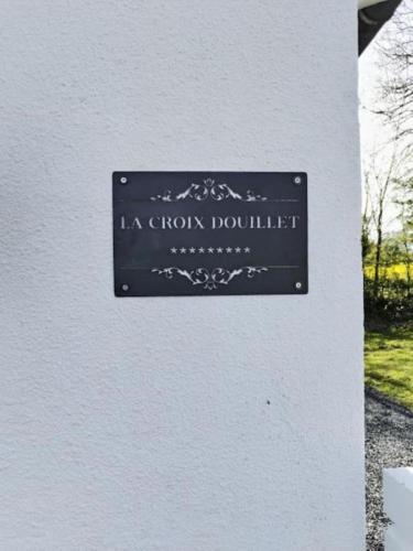 a sign on the side of a building at La Croix Douillet in Gavray