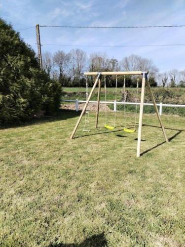 a swing set in a yard with at La Croix Douillet in Gavray