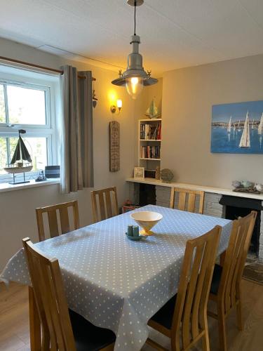 a dining room table with a polka dot table cloth at Hollyhocks in Saint Minver