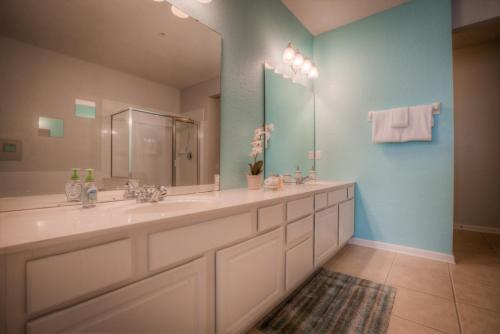 uma casa de banho com 2 lavatórios e um espelho grande em Vista Cay 70 by Top Villas em Orlando