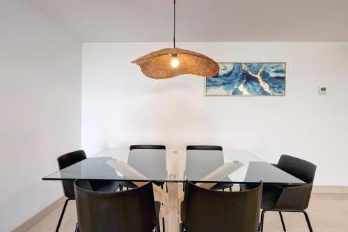 a dining room with a table and chairs at Aqua Apartments Vento, Marbella in Marbella