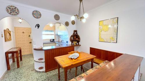 a kitchen with a wooden table and a counter at Cap llarg in Roses