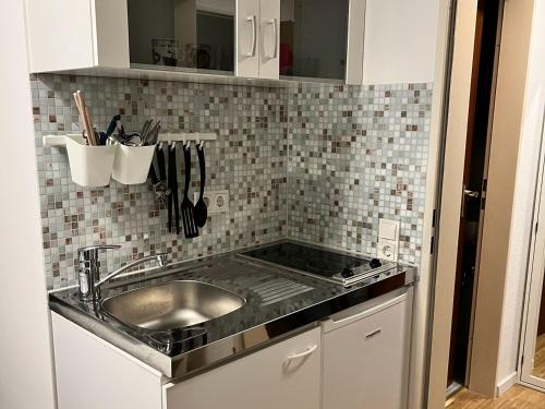 a kitchen with a sink and a counter top at Nice Apartment in Düsseldorf in Düsseldorf