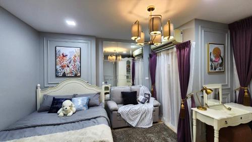 a bedroom with a bed with a teddy bear on it at Thapra residence,next to bts,The mall,Icon Siam,Siam Paragon,Central World in Thonhuri