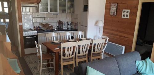 a kitchen with a table and chairs in a room at Les Isards Pied des pistes in Ax-les-Thermes