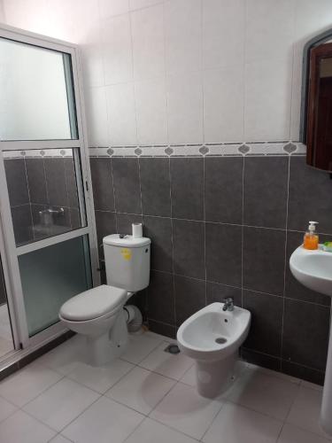 a bathroom with a toilet and a sink at appartement à larache in Larache