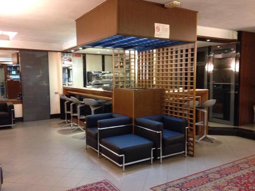 a bar in a restaurant with chairs and wine racks at Hotel Barsotti in Brindisi