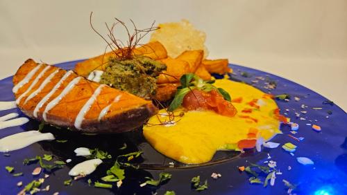 a blue plate of food with eggs and chips at Landhotel Mariensäule in Wernstein am Inn