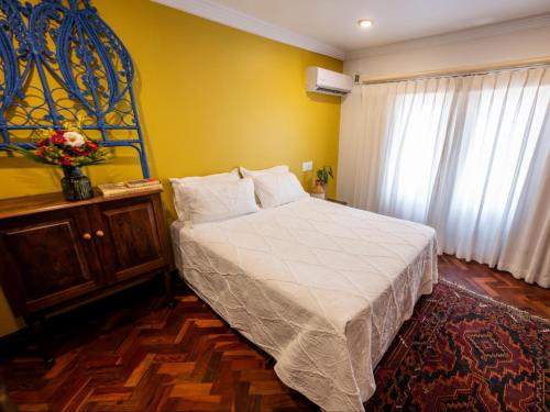 a bedroom with a large bed and a window at Bella Bohemia Spa, Venue and Guest Farm in Roodeplaat