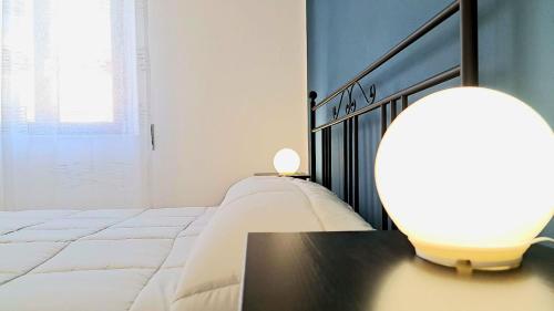 a bedroom with a bed and a table with a lamp at Anninnìa Guest House B&B - GhiIarza in Ghilarza