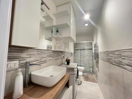 a white bathroom with a sink and a toilet at i giardini di edicart in Bari