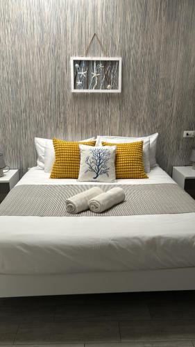 a large bed with two pillows on top of it at Rais in San Vito lo Capo