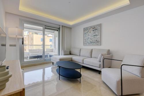 a living room with a couch and a table at Aqua Apartments Vento, Marbella in Marbella