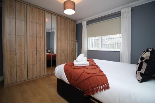 a bedroom with a large bed and a window at The Nook by Tŷ SA - Near Bike Park Wales in Nelson