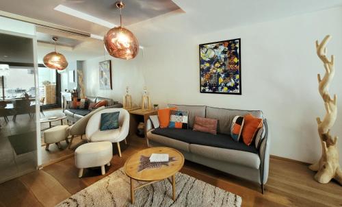 a living room with a couch and a table at L'Eau Vive Jacuzzi et Sauna en vieille ville 5 in Annecy