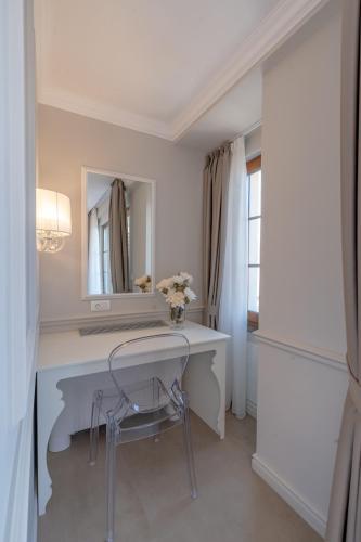 a white bathroom with a desk and a mirror at Villa & Spa Chunarot in Ohrid