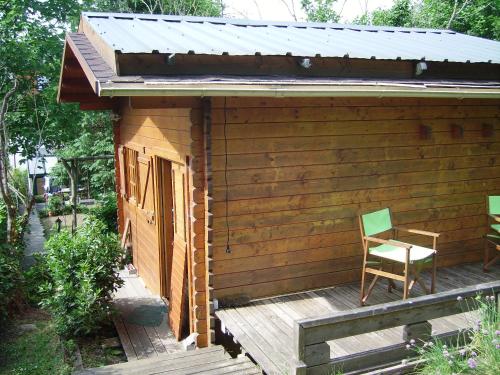 une cabine en bois avec une chaise sur une terrasse dans l'établissement Chalet indépendant proche centre ville, au Mans
