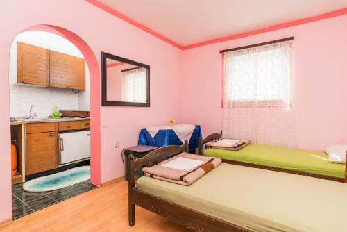 a room with two beds and a kitchen at Studios Kaštel in Buje