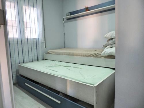 two bunk beds in a room with a mirror at Tu oasis, a la orilla del mar in Salou