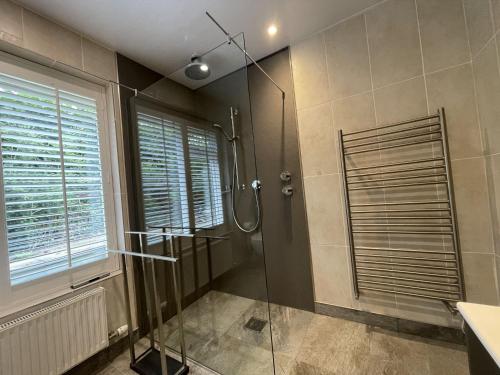 a bathroom with a shower and a glass shower stall at Pinecroft in Keswick