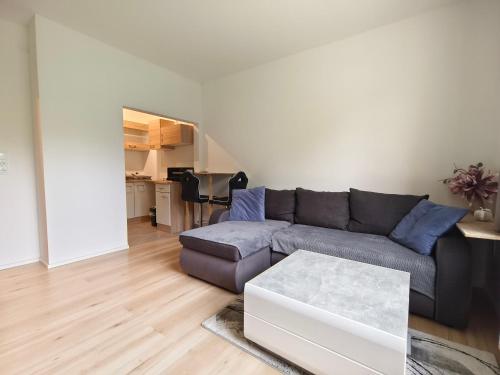 a living room with a couch and a table at City rooms in Kapfenberg