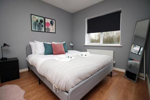 a bedroom with a bed with two trays on it at Usk Way by Tŷ SA in Newport
