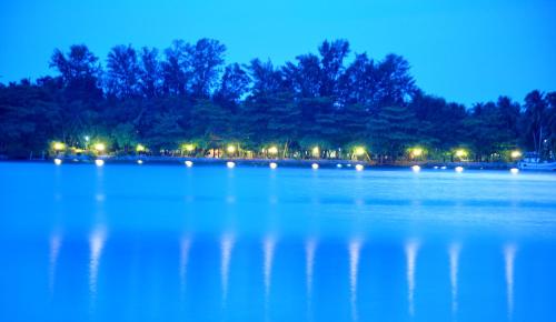 a large body of water at night with lights at Riviera Resort in Batticaloa