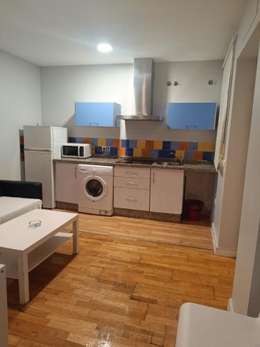 a kitchen with a table and a stove top oven at Apartamentos Aloha 2 Centro El Puerto de Santa Maria in El Puerto de Santa María