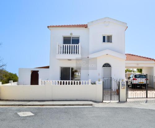 a white house with a white fence at Villa Lankas with Heated pool in Ayia Napa