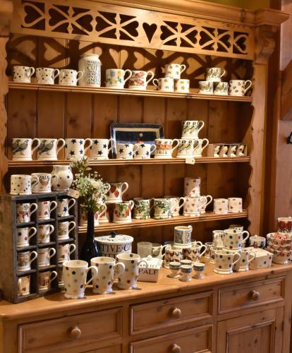 a shelf filled with lots of tea cups and bowls at B&B De Pastorie bij Dokkum in Reitsum