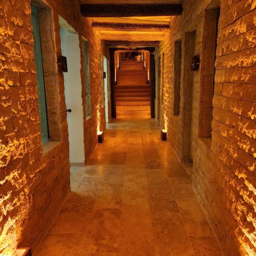 an empty hallway in an old building with brick walls at Fresco Cave Suites Cappadocia in Urgup