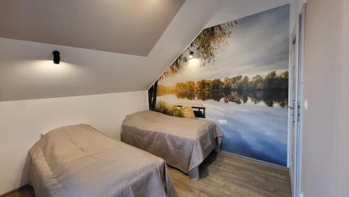 duas camas num quarto com vista para um lago em Rybitwy Residence em Mielno