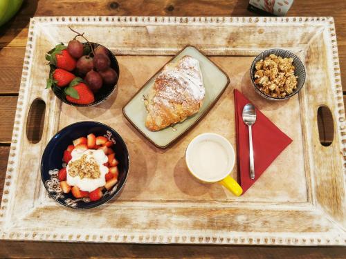 a table with plates of food and bowls of fruit at B&B Le Noci in Ascoli Piceno