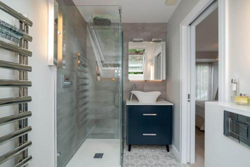 a bathroom with a sink and a shower at GuestReady - Family Stay in the heart of Fulham in London