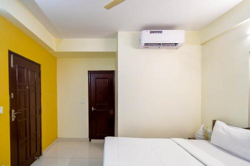 a bedroom with a bed and a air conditioner on the wall at Hotel Mahal in kolkata