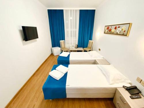 Кровать или кровати в номере QUL-Khadisha